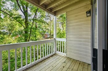 the view from the porch of a cabin with a porch swing at Waldan Pond Apartments, Acworth, GA, 30102